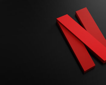 Red angular N shape on a dark, almost black background.